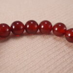 Close-up of red agate bracelet with S925 silver accents.