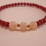 Close-up of red agate and white chalcedony bracelet.