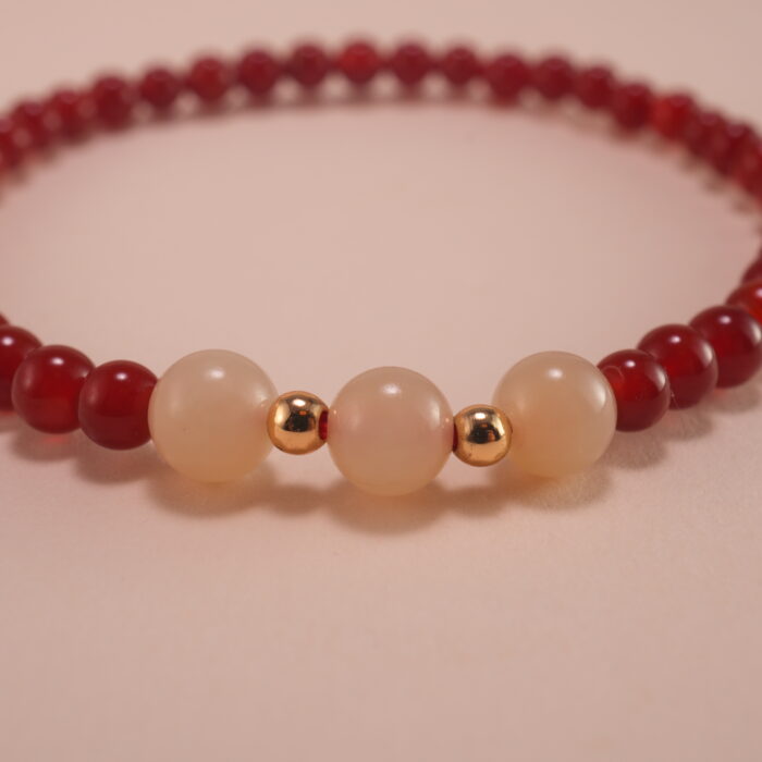 Close-up of red agate and white chalcedony bracelet.
