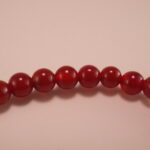 Close-up of red agate and white chalcedony bracelet.