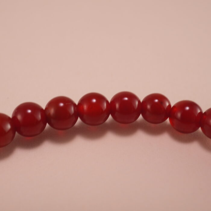 Close-up of red agate and white chalcedony bracelet.