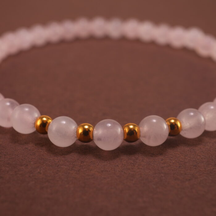 Close-up of rose quartz bracelet.