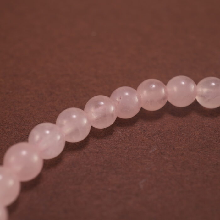 Close-up of rose quartz bracelet.