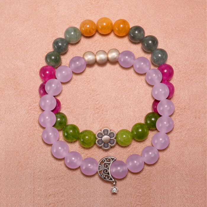Main product image showing stacked amethyst and tourmaline crystal bracelets.