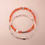 Main image of red carnelian and white chalcedony stacked bracelets.