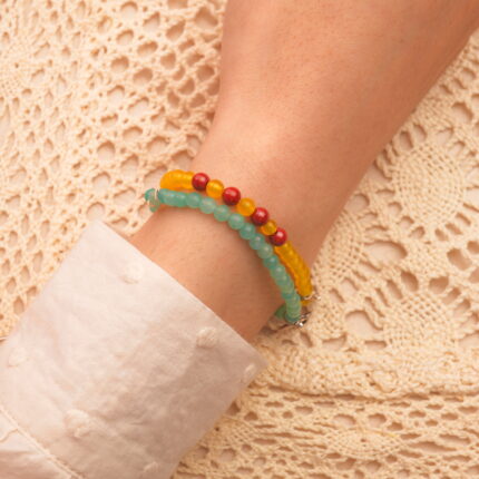 Model wearing yellow agate, cinnabar and amazonite stack.