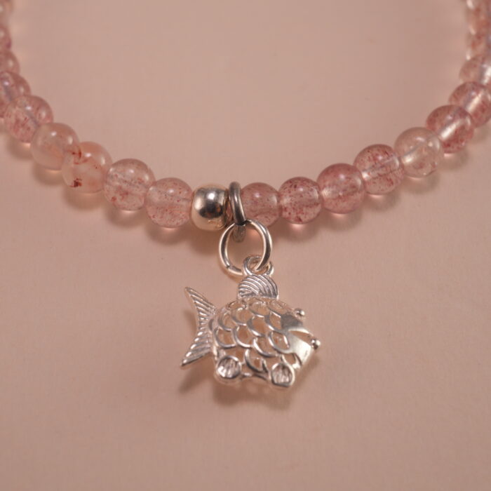 Close-up of strawberry quartz bracelet with silver.