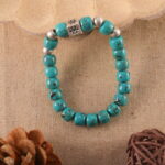 Turquoise bracelet in natural light with bold blue tones.