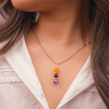Model wearing Virgo zodiac necklace with yellow agate, garnet, and amethyst.