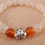 Close-up of white chalcedony and orange agate bracelet with S925 silver.
