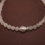 Close-up of white chalcedony bracelet with silver.