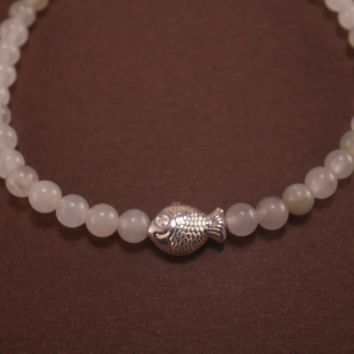 Close-up of white chalcedony bracelet with silver.
