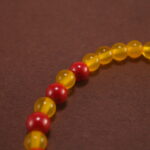 Close-up of yellow agate and cinnabar bracelet with silver.