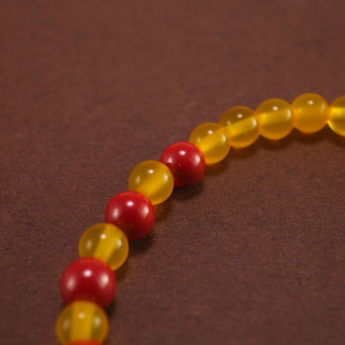 Close-up of yellow agate and cinnabar bracelet with silver.