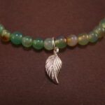 Close-up of yellow-green chalcedony bracelet with silver.