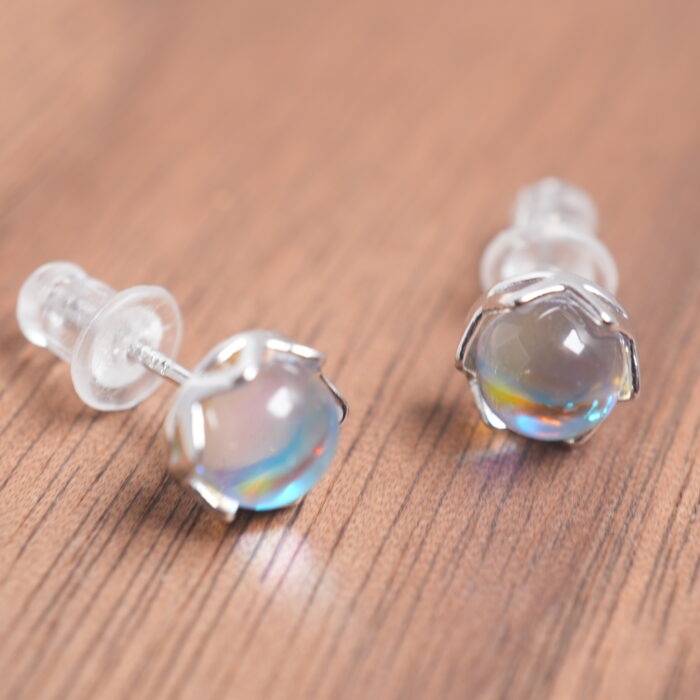 Close-up of the moonstone studs, showing blue iridescence and smooth cabochon cut.