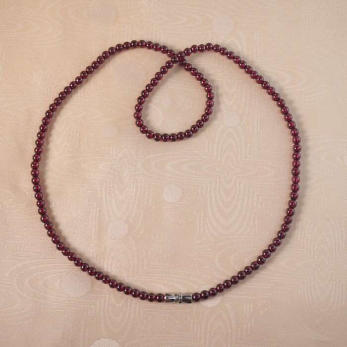 Garnet round bead necklace on white background