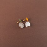 A pair of yellow-green chalcedony and raw quartz earrings displayed on a clean background, with a fresh and natural color tone.